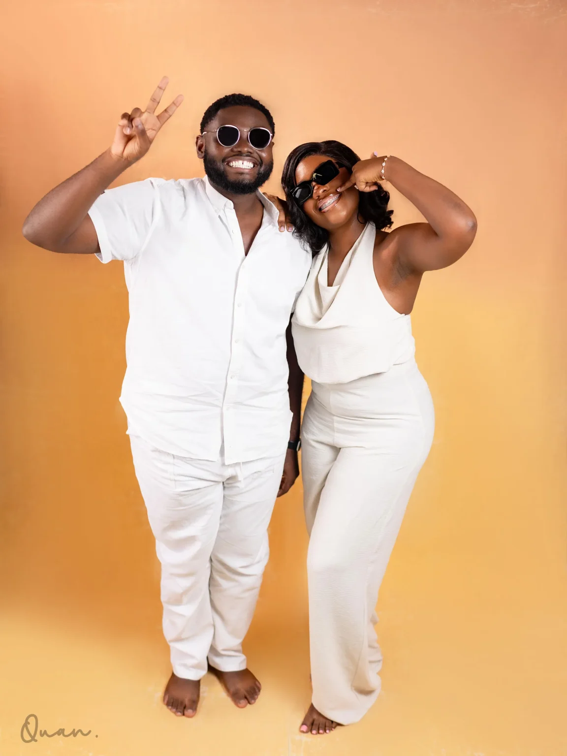 Kwaku and Tess in sunglasses, laughing
